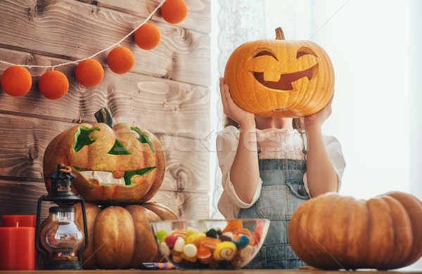 Stock photo: girl with carving pumpkin