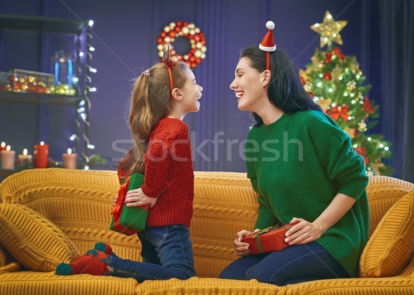 Mother and daughter exchanging gifts Stock photo © choreograph