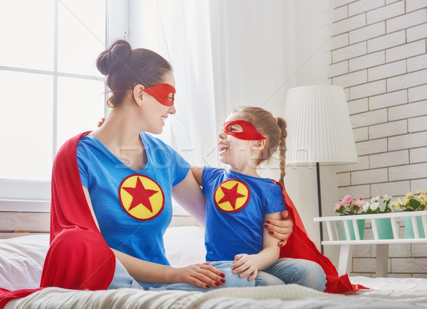 Stock photo: Girl and mom in Superhero costume