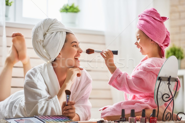 Mother and daughter are doing make up Stock photo © choreograph
