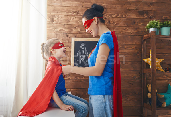 Girl and mom in Superhero costume Stock photo © choreograph