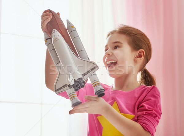 girl playing with toy rocket Stock photo © choreograph