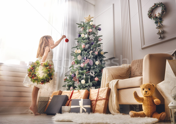 girl is decorating the Christmas tree Stock photo © choreograph