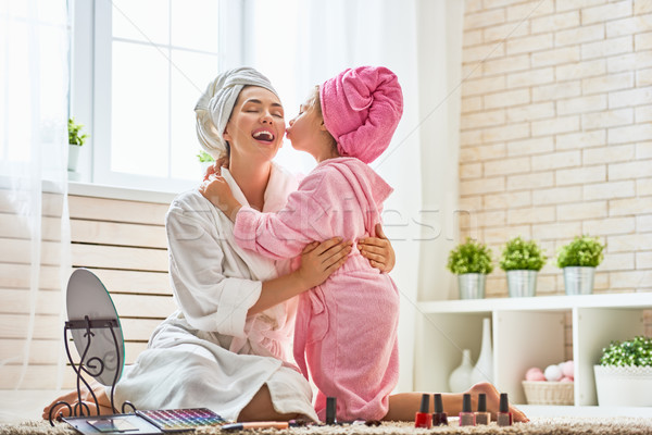 Mother and daughter are doing make up Stock photo © choreograph