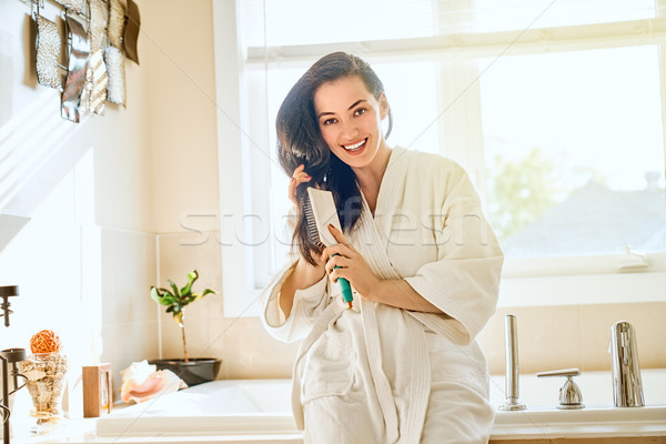 woman is combing hair Stock photo © choreograph