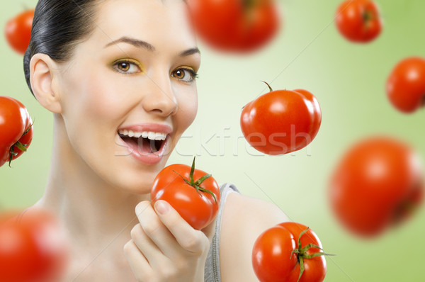 Piros paradicsom gyönyörű karcsú lány eszik Stock fotó © choreograph