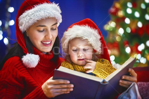 mother reading a book at Christmas Stock photo © choreograph