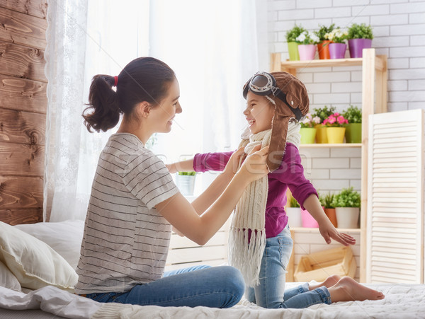 Mother and child girl playing Stock photo © choreograph