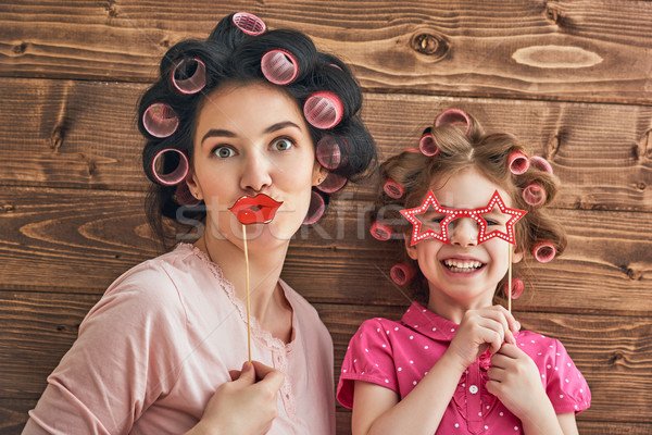 Stock photo: Mother and daughter with paper accessories