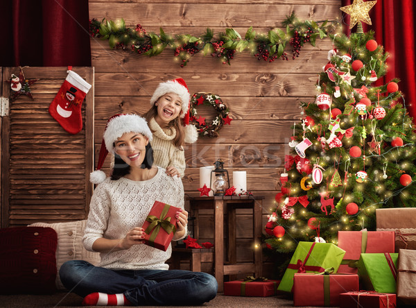 Mother and daughter exchanging gifts Stock photo © choreograph