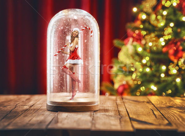 Santa girl inside a Christmas snow globe. Stock photo © choreograph