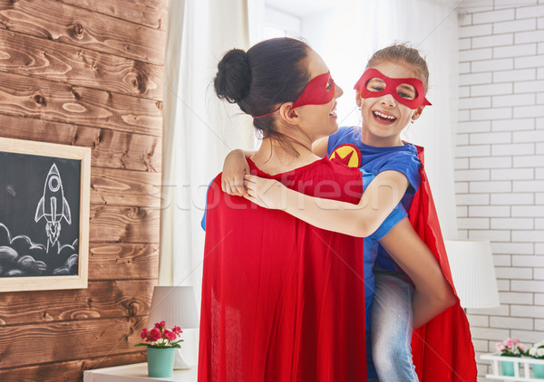 Girl and mom in Superhero costume Stock photo © choreograph