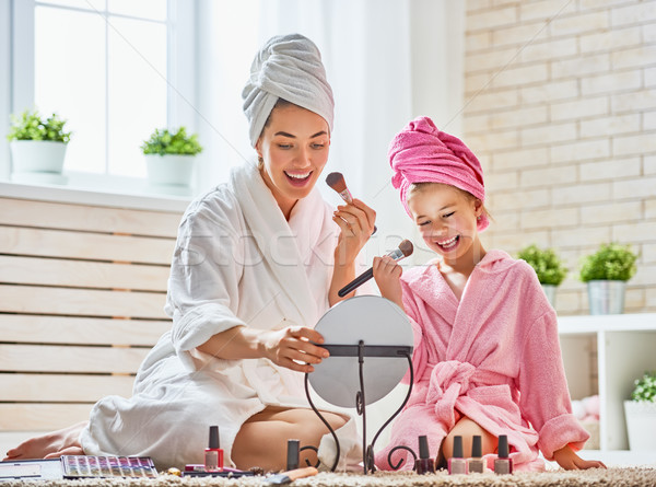 Mother and daughter are doing make up Stock photo © choreograph