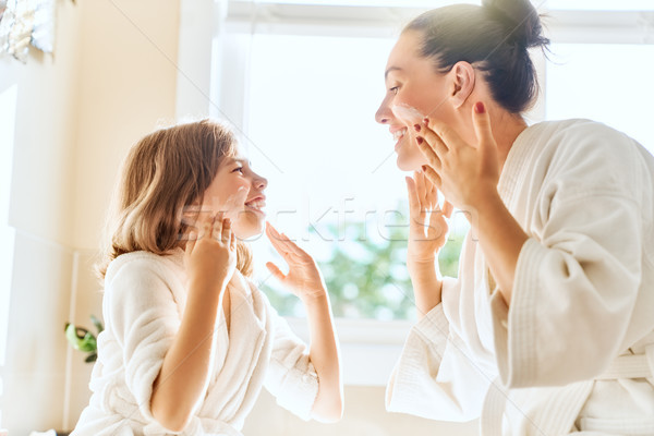 Mother and daughter caring for skin Stock photo © choreograph