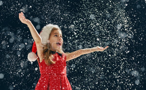 Stock photo: little girl catching snowflakes