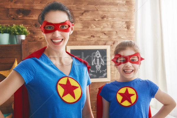 Stock photo: Girl and mom in Superhero costume