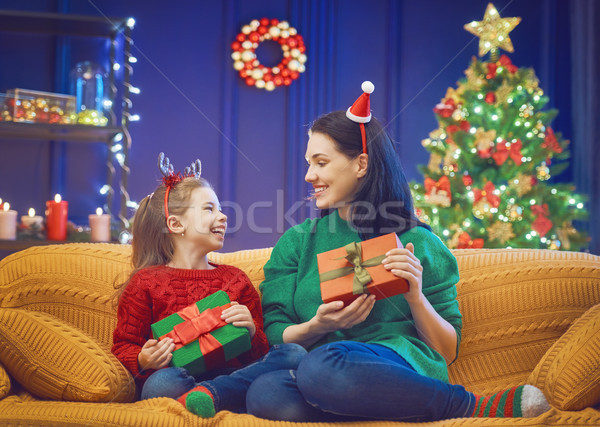 Mother and daughter exchanging gifts Stock photo © choreograph