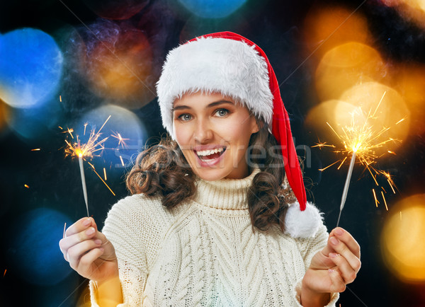 Gyönyörű nő tart boldog új évet mosoly buli tűz Stock fotó © choreograph