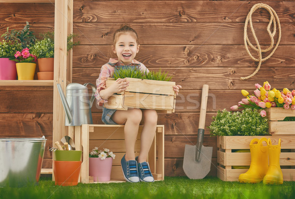 girl caring for her plants Stock photo © choreograph