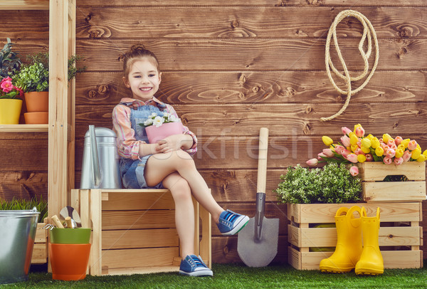 Stock photo: girl caring for her plants