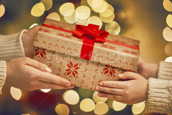 Hands giving x-mas gift Stock photo © choreograph