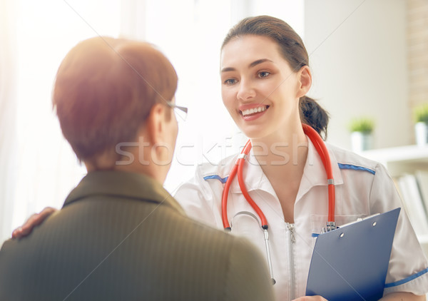 Female patient listening to doctor Stock photo © choreograph