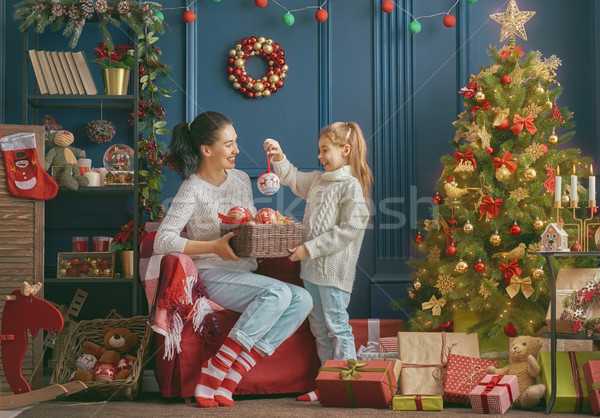 Mom and daughter decorate the tree Stock photo © choreograph