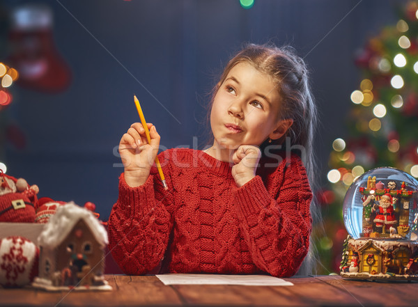girl is writing the letter to Santa Stock photo © choreograph
