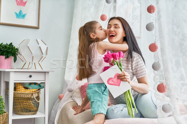 Stock photo: daughter is congratulating mom