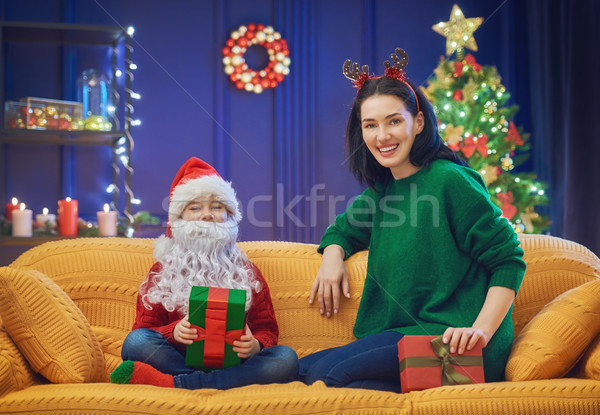 Mother and daughter exchanging gifts Stock photo © choreograph