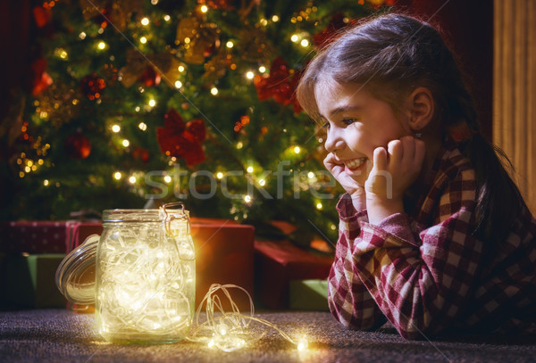 Stock photo: girl is decorating the Christmas tree