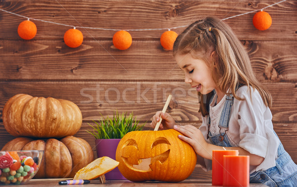girl with carving pumpkin Stock photo © choreograph