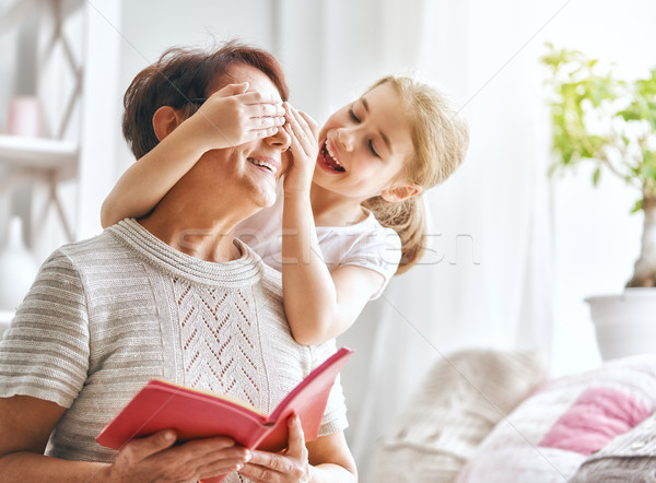 Grandmother reading a book to granddaughter Stock photo © choreograph