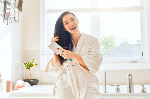 woman is combing hair Stock photo © choreograph