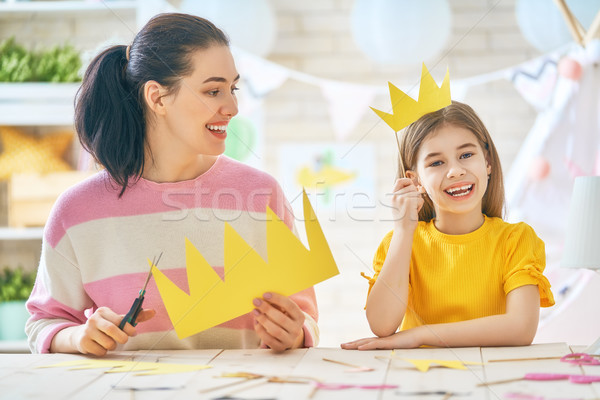 Mother and daughter with paper accessories Stock photo © choreograph