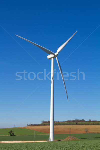 Stock photo: Wind turbine under clear blue sky