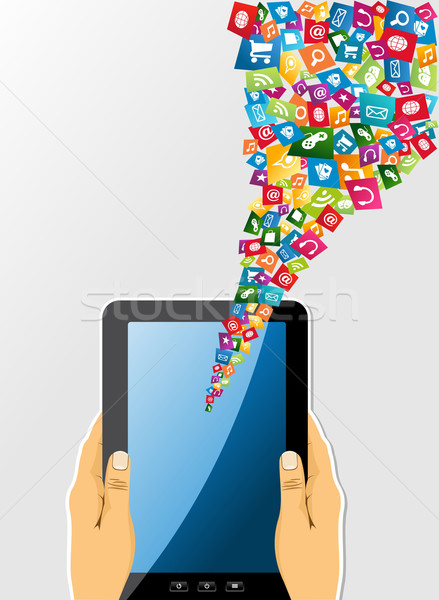 Human hands holds tablet pc with app icons. Stock photo © cienpies