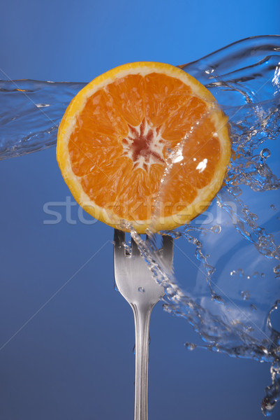 Orange fruit fork water splash blue concept health Stock photo © cienpies