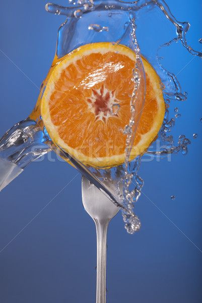 Orange fruit fork water splash blue concept health Stock photo © cienpies