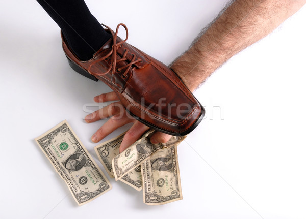 Shoe crushing a hand that holds money. White background Stock photo © cienpies