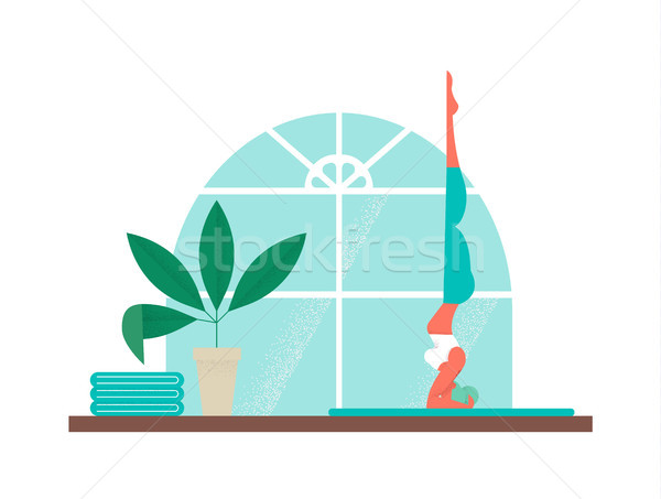 Girl doing yoga sport headstand at home studio Stock photo © cienpies