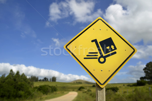 Shipping concept delivery box cart on road sign Stock photo © cienpies