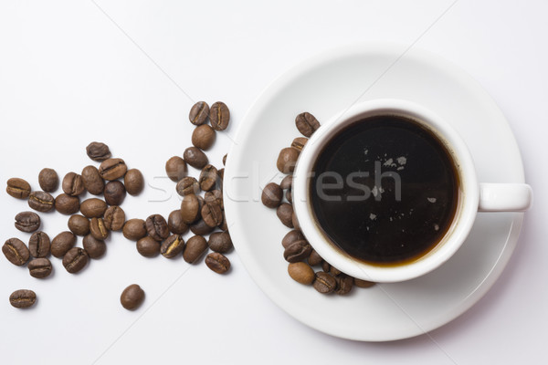 Top view of coffe cup with beans over white Stock photo © cienpies