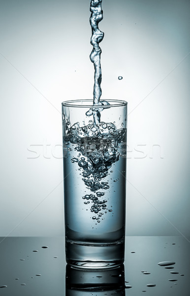 Water splashing from glass Stock photo © Cipariss
