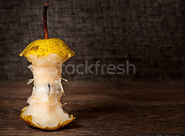 Stub of pear on wooden table Stock photo © Cipariss
