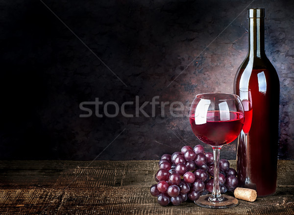 Glass of red wine with grapes and bottle Stock photo © Cipariss