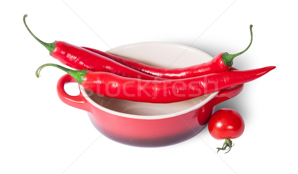 Chili peppers on the saucepan and cherry tomatoes near Stock photo © Cipariss
