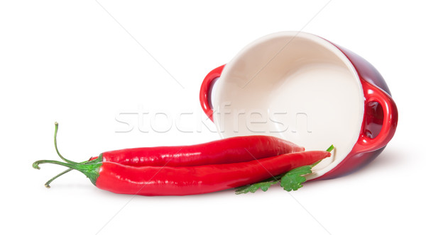 Chili pepper and parsley near inverted pan Stock photo © Cipariss