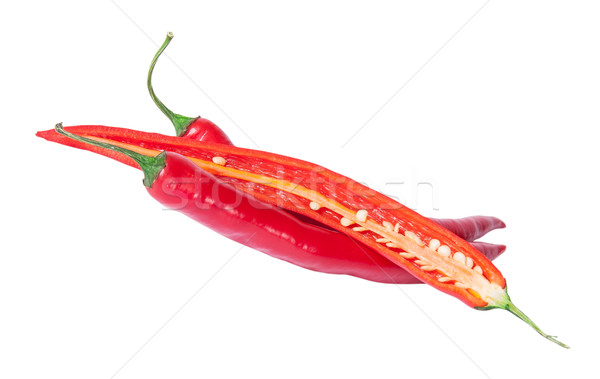 Two whole and one half red chili peppers deployed Stock photo © Cipariss