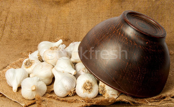 Garlic spill out of a ceramic bowl Stock photo © Cipariss